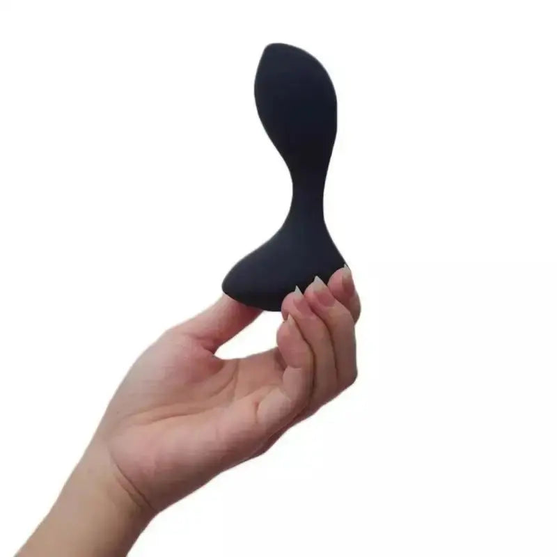 Plug anal vibrant tenu par une main, accessoire de plaisir en silicone ABS.