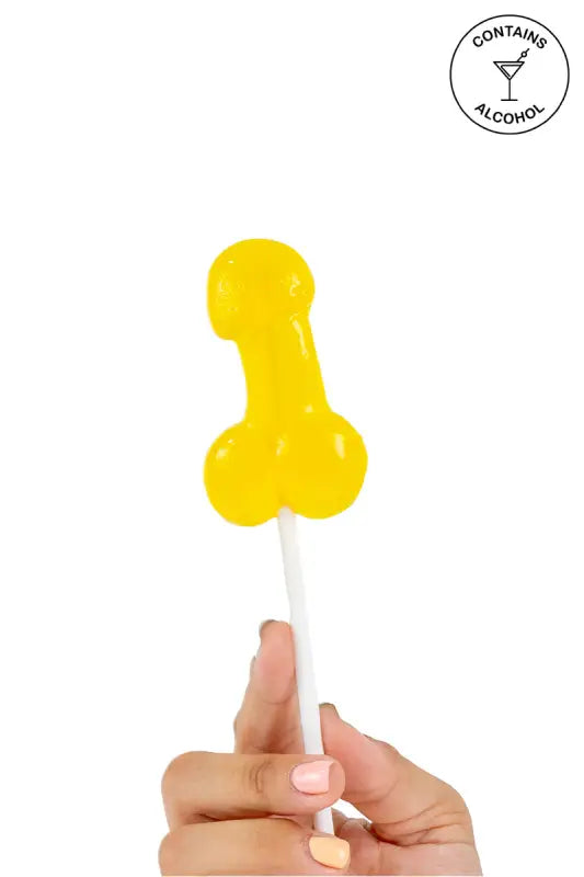 Sucette jaune en forme de pénis.
