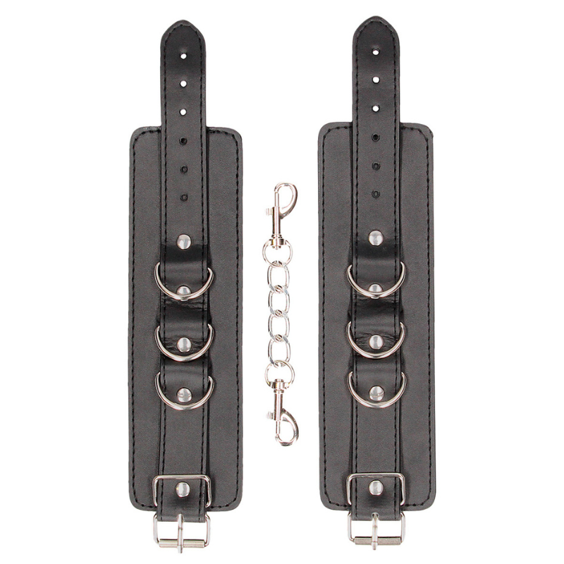 Menottes cuir Ouch! en cuir noir avec anneaux métalliques pour jeux BDSM et domination.