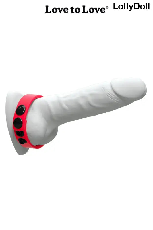 Anneau de bite rouge avec boutons noirs.